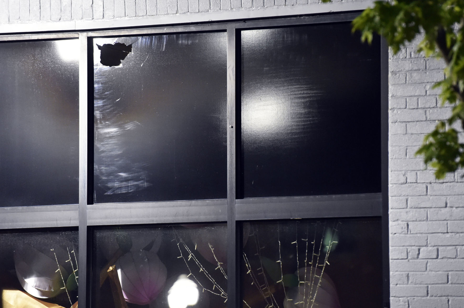 Rock through window at salon